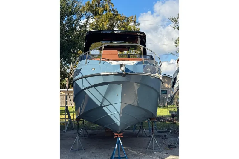 Slide: The Image of 2025 NX Boats NX290 Exclusive yacht on stands, front view under clear sky. - 28