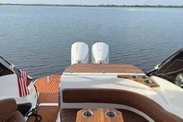 Slide: The Image of 2025 NX Boats NX290 Exclusive on water, featuring luxurious seating and dual engines. - 6
