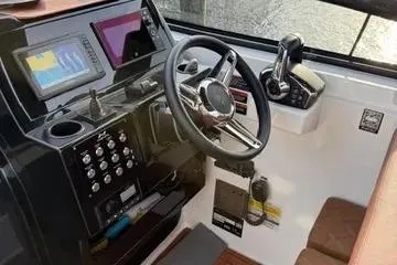 Slide: The Image of 2025 NX Boats NX290 Exclusive dashboard with modern controls and navigation screens. - 7