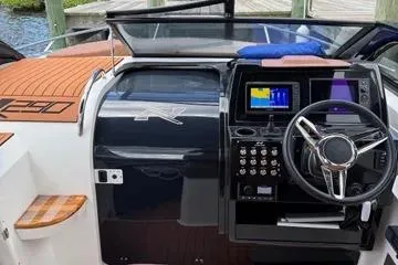 Slide: The Image of 2025 NX Boats NX290 Exclusive dashboard with modern controls and navigation system. - 9