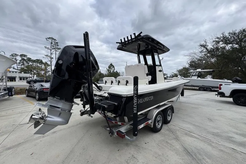 Slide: The Image of 2026 ShearWater 260 Carolina Flare boat on trailer, featuring powerful outboard motor. - 11