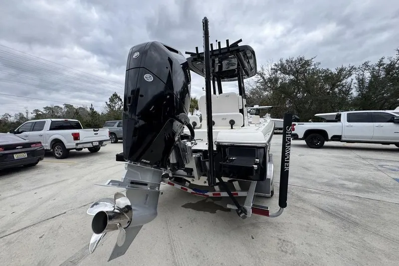 Slide: The Image of 2026 ShearWater 260 Carolina Flare boat with powerful outboard motor in parking lot. - 12