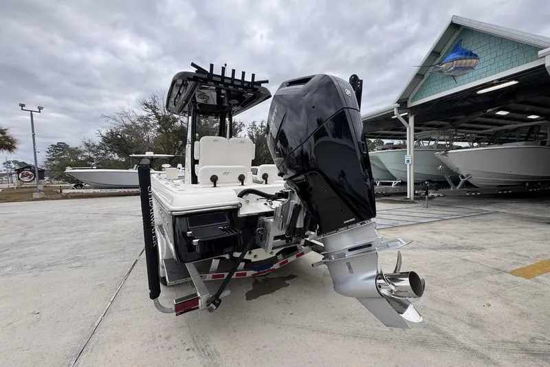 Slide: The Image of 2026 ShearWater 260 Carolina Flare boat with powerful outboard motor in a marina. - 14