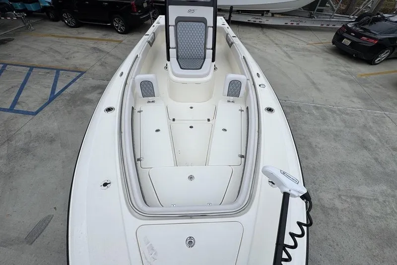 Slide: The Image of 2026 ShearWater 260 Carolina Flare boat, spacious deck view in a parking lot. - 21