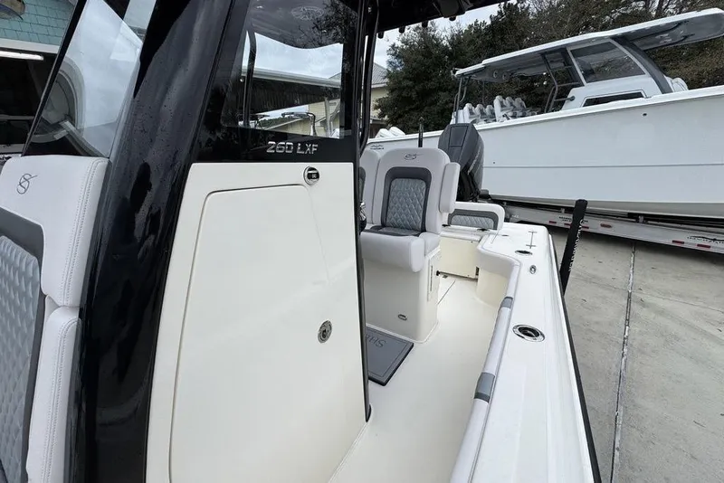 Slide: The Image of 2026 ShearWater 260 Carolina Flare boat interior with sleek seating and modern design. - 24