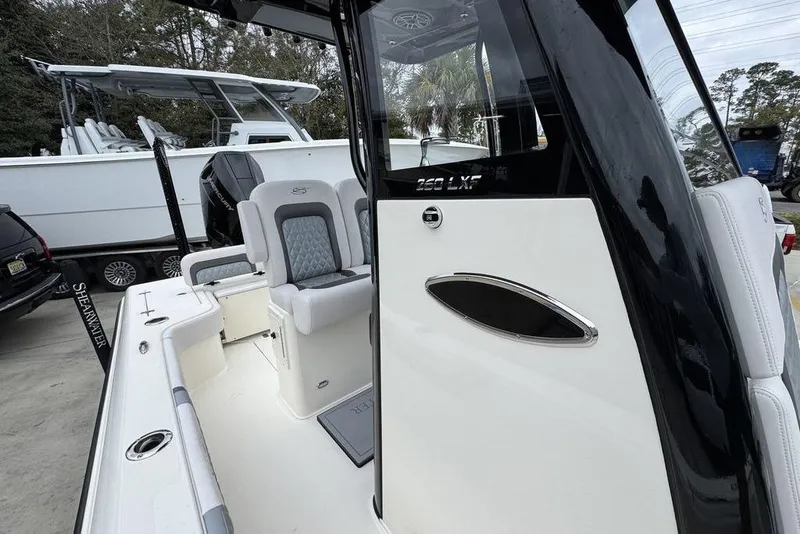 Slide: The Image of 2026 ShearWater 260 Carolina Flare boat interior with sleek seating and modern design. - 25