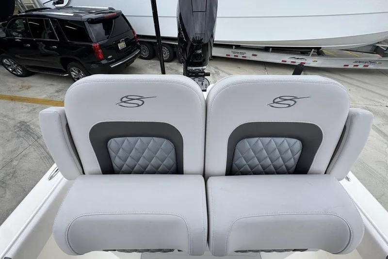 Slide: The Image of Luxury seating on 2026 ShearWater 260 Carolina Flare boat, featuring quilted design and logo. - 27