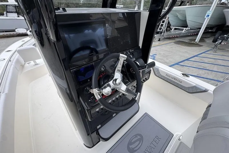 Slide: The Image of 2026 ShearWater 260 Carolina Flare boat dashboard with steering wheel and controls. - 29