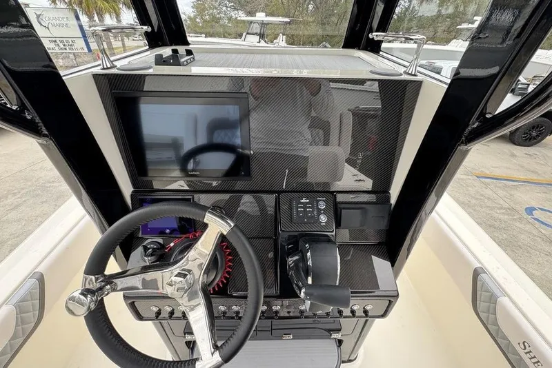 Slide: The Image of 2026 ShearWater 260 Carolina Flare boat dashboard with steering wheel and control panel. - 30