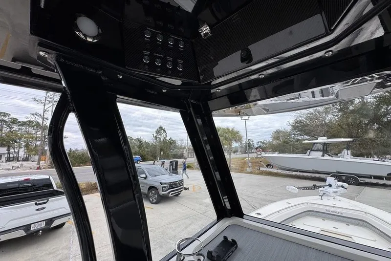 Slide: The Image of Interior view of 2026 ShearWater 260 Carolina Flare boat, showcasing sleek design and controls. - 32