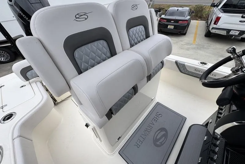 Slide: The Image of 2026 ShearWater 260 Carolina Flare boat interior with luxury seating and steering wheel. - 34