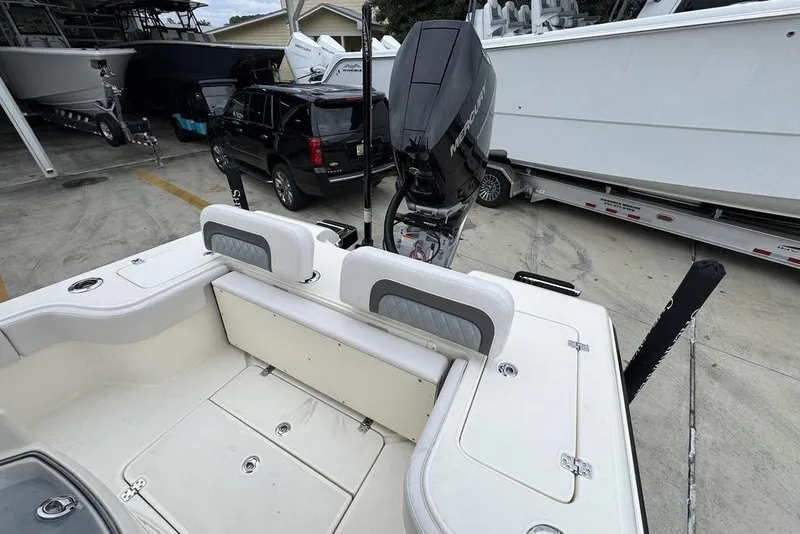 Slide: The Image of 2026 ShearWater 260 Carolina Flare boat with Mercury engine in a marina setting. - 37