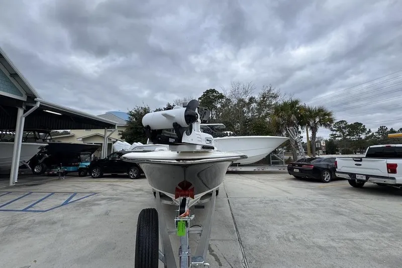 Slide: The Image of 2026 ShearWater 260 Carolina Flare boat on trailer in parking lot under cloudy sky. - 5