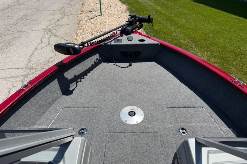 Slide: The Image of 2019 Tracker Pro Guide V-175 WT boat deck with trolling motor, red trim, and gray carpet. - 2