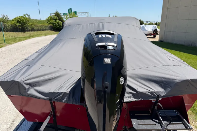 Slide: The Image of 2019 Tracker Pro Guide V-175 WT boat with Mercury 115 engine, covered and parked outdoors. - 5