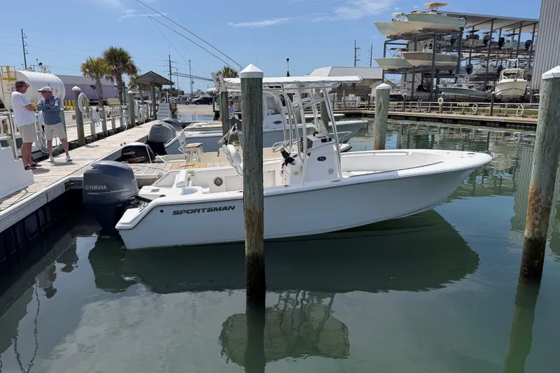 The Image of 2015 Sportsman Open 212 Center Console boat docked at marina with Yamaha engine. - 1
