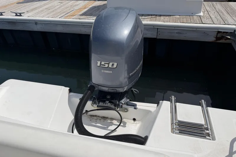 Slide: The Image of 2015 Sportsman Open 212 Center Console with Yamaha 150 outboard motor at dock. - 10