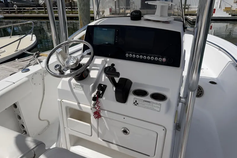 Slide: The Image of 2015 Sportsman Open 212 Center Console boat dashboard with steering wheel and controls. - 14