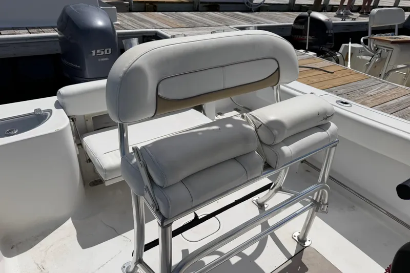 Slide: The Image of 2015 Sportsman Open 212 Center Console boat interior with cushioned seating and Yamaha 150 engine. - 15