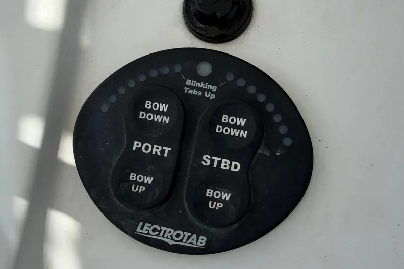 Slide: The Image of Control panel of a 2015 Sportsman Open 212 Center Console boat, featuring Lectrotab trim tab controls. - 17