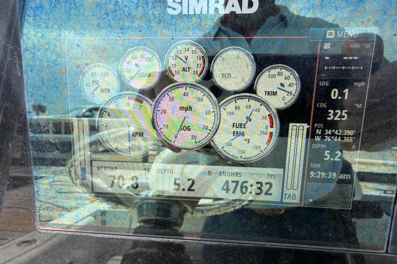 Slide: The Image of Simrad display on 2015 Sportsman Open 212 Center Console showing engine metrics and navigation data. - 18