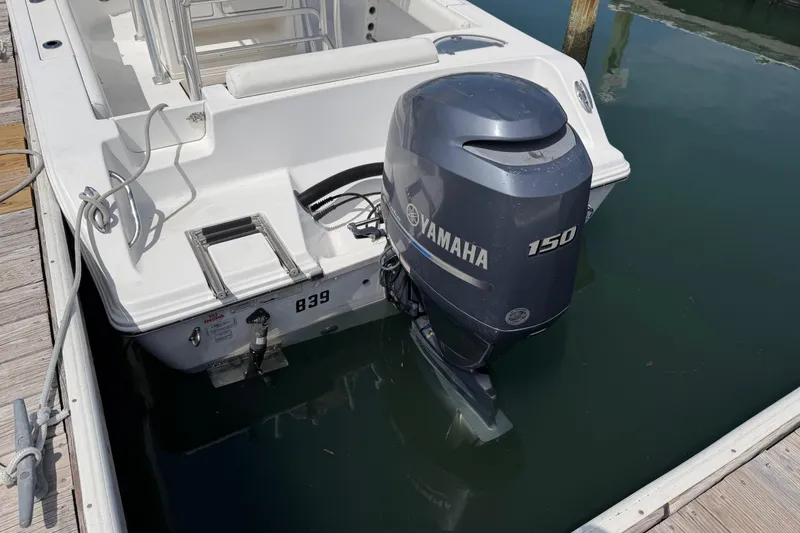 Slide: The Image of 2015 Sportsman Open 212 Center Console with Yamaha 150 outboard motor at dock. - 4
