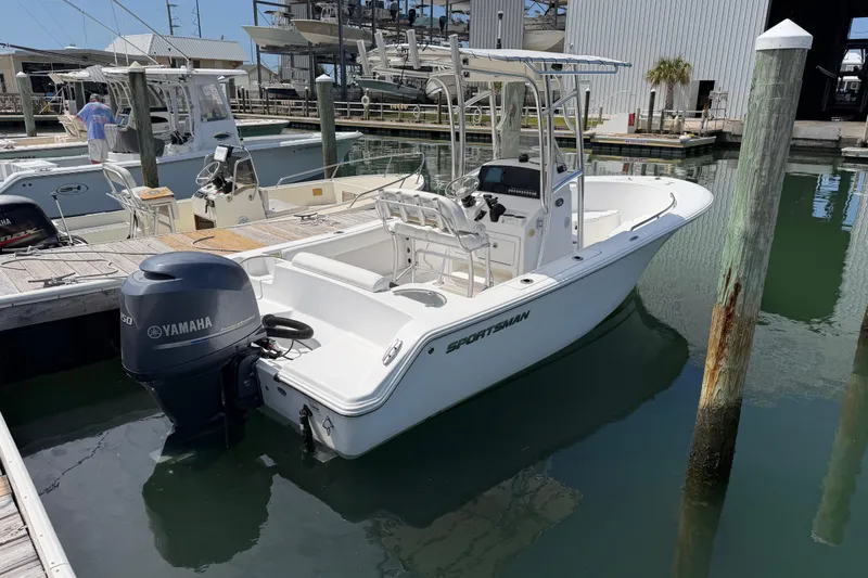 Slide: The Image of 2015 Sportsman Open 212 Center Console boat docked with Yamaha outboard motor. - 5