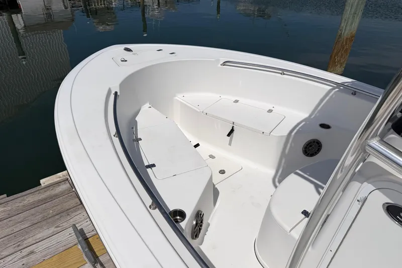 Slide: The Image of 2015 Sportsman Open 212 Center Console boat interior, docked by calm water. - 7