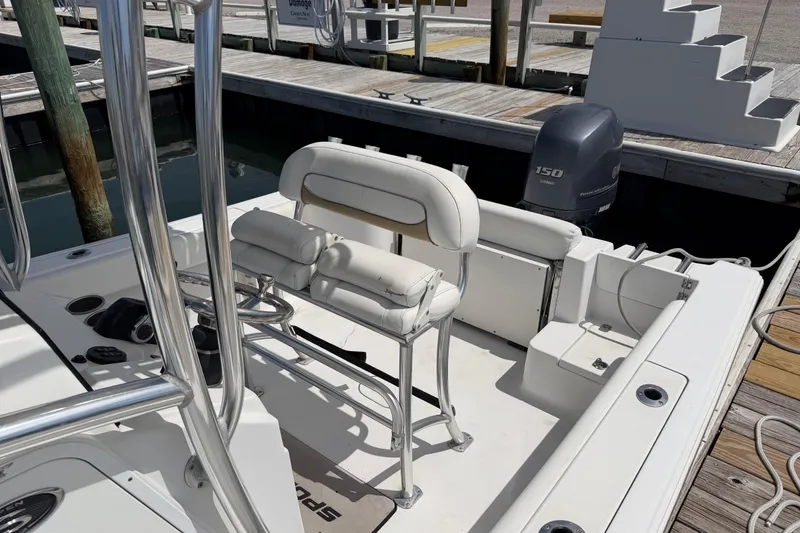 Slide: The Image of 2015 Sportsman Open 212 Center Console boat docked, featuring seating and Yamaha 150 engine. - 8