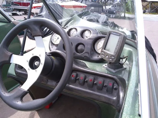 Slide: The Image of Dashboard of a 2006 Stratos ST486F boat with steering wheel and instruments. - 5