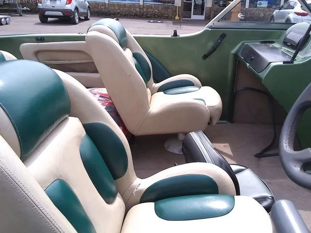 Slide: The Image of Interior of a 2006 Stratos ST486F boat with green and beige seats. - 7