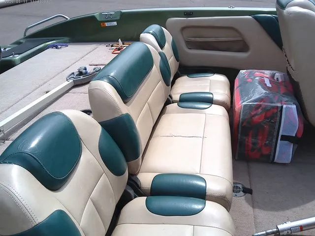 Slide: The Image of Interior of a 2006 Stratos ST486F boat with green and beige seats. - 8