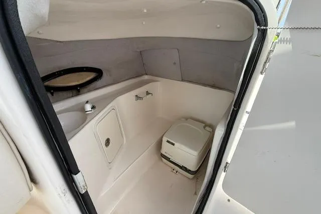 Slide: The Image of 2005 Hurricane SunDeck 217 OB boat interior with compact marine toilet and sink. - 11