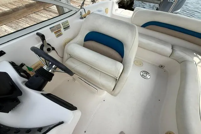 Slide: The Image of 2005 Hurricane SunDeck 217 OB boat interior with steering wheel and seating area. - 12