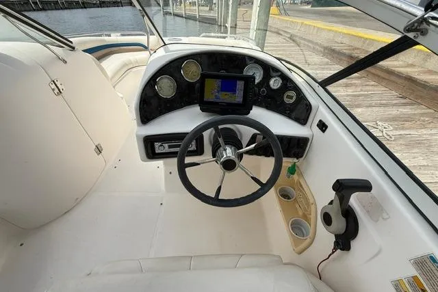 Slide: The Image of 2005 Hurricane SunDeck 217 OB boat cockpit with steering wheel and navigation system. - 13