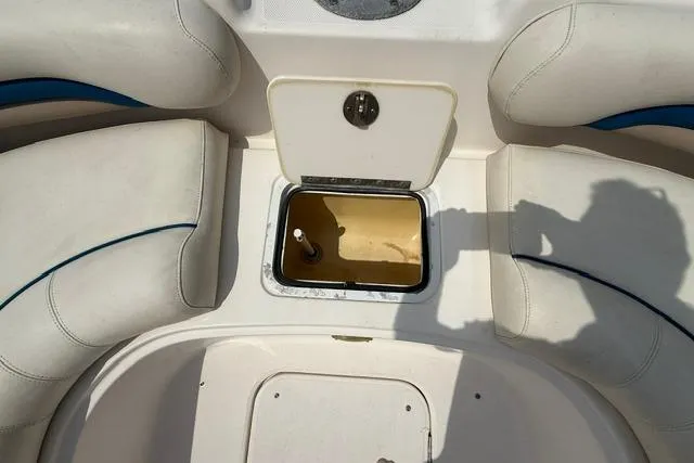 Slide: The Image of 2005 Hurricane SunDeck 217 OB boat interior with open storage compartment. - 15
