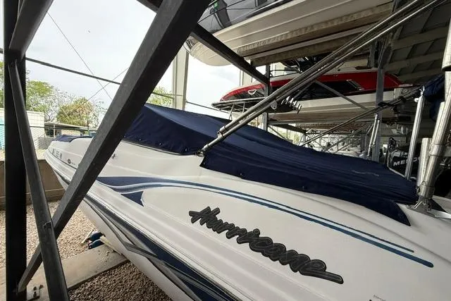 Slide: The Image of 2005 Hurricane SunDeck 217 OB boat in storage, covered and secured. - 3