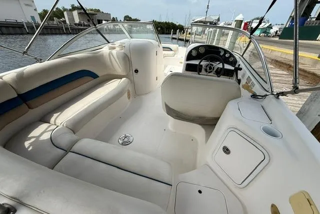 Slide: The Image of 2005 Hurricane SunDeck 217 OB boat interior with spacious seating and steering console. - 9