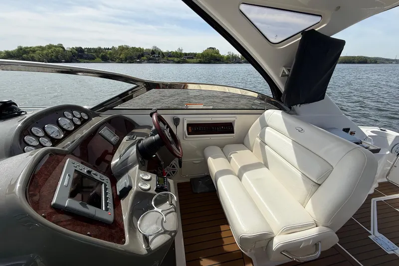 Slide: The Image of 2008 Regal 3760 Sportyacht cockpit with leather seating and modern dashboard on a sunny day. - 13