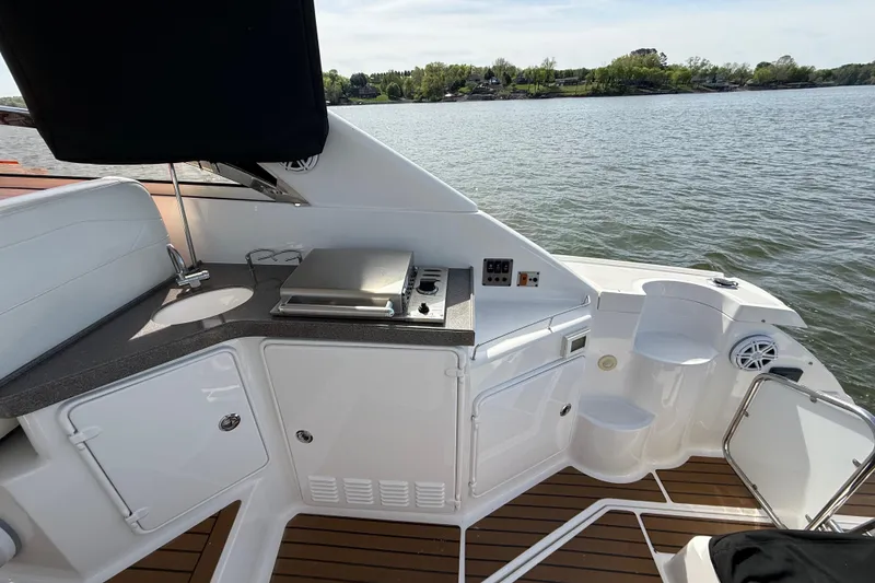 Slide: The Image of 2008 Regal 3760 Sportyacht deck with outdoor kitchen and scenic water view. - 15