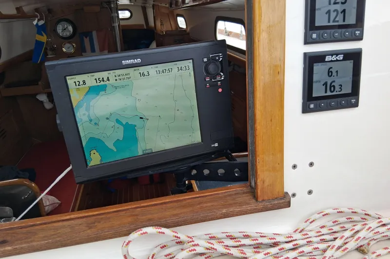 Slide: The Image of Navigation equipment on a 1967 Hinckley Pilot 35 sailboat, displaying nautical charts and data. - 12