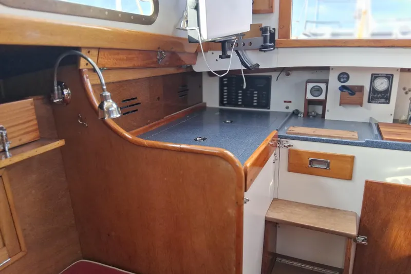 Slide: The Image of 1967 Hinckley Pilot 35 yacht interior with wooden cabinetry and navigation instruments. - 13