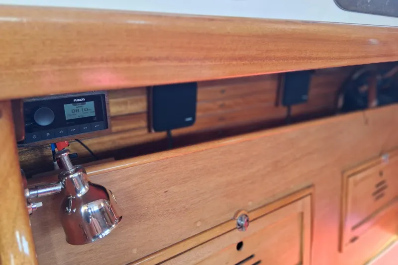 Slide: The Image of Interior of 1967 Hinckley Pilot 35 with wooden cabinetry and modern radio system. - 18