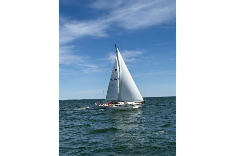 Slide: The Image of Sailboat Hinckley Pilot 35 from 1967 on open water under blue sky. - 2