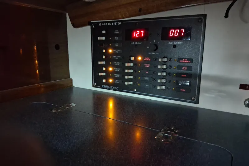 Slide: The Image of Electrical panel on a 1967 Hinckley Pilot 35 sailboat, displaying voltage and current readings. - 20