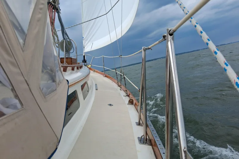 Slide: The Image of Sailing on a 1967 Hinckley Pilot 35 yacht under cloudy skies. - 21