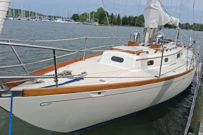 Slide: The Image of 1967 Hinckley Pilot 35 sailboat docked in a marina, showcasing classic design. - 3