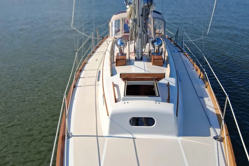 Slide: The Image of 1967 Hinckley Pilot 35 sailboat deck view on calm water. - 4