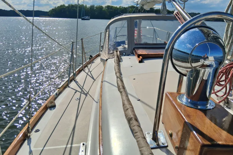 Slide: The Image of 1967 Hinckley Pilot 35 sailboat deck with scenic water view. - 6
