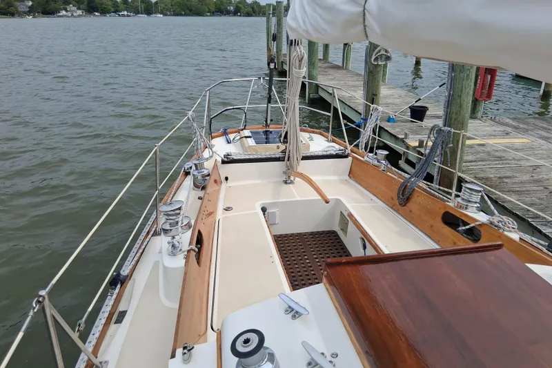 Slide: The Image of 1967 Hinckley Pilot 35 sailboat docked, showcasing deck and cockpit details. - 8